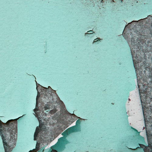 Peeling teal paint texture on a wall