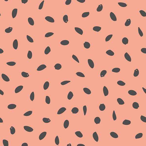 Scattered black seeds on a salmon pink background