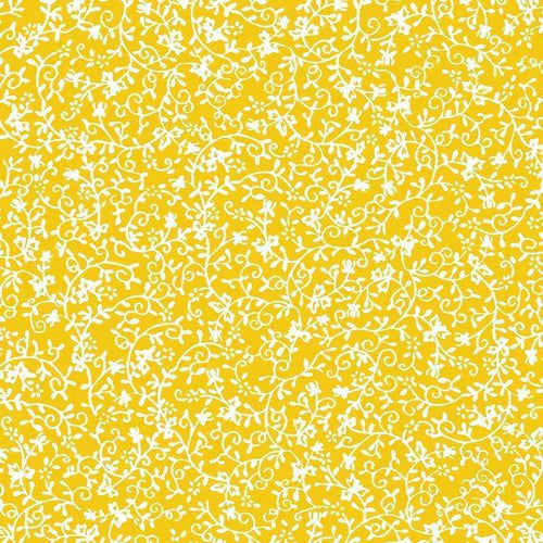 Intricate white floral pattern over a vibrant yellow background