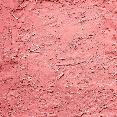 Close-up of a textured coral pink plaster pattern