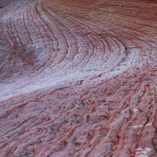 Swirling red and white rock pattern