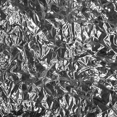 Close-up of crumpled foil texture with light reflections