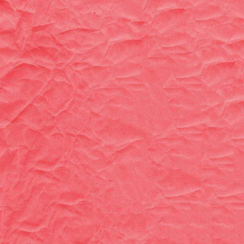 Crumpled paper texture in coral pink