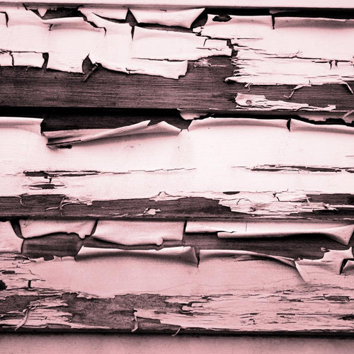 Textured pattern of weathered and peeling paint on wooden planks