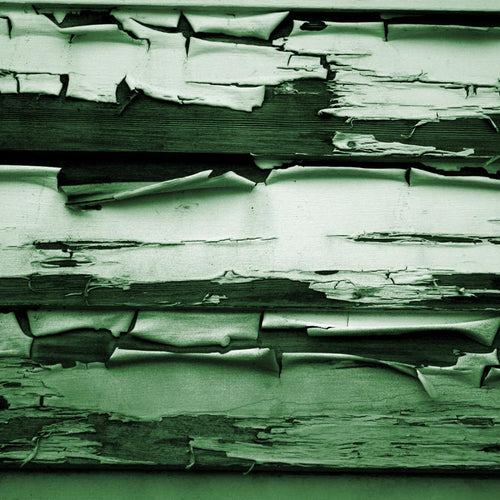 Green-toned peeling paint on wooden planks