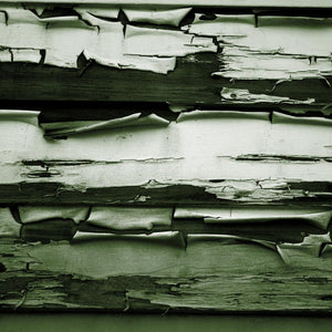 Grungy green and white peeling paint on wooden planks