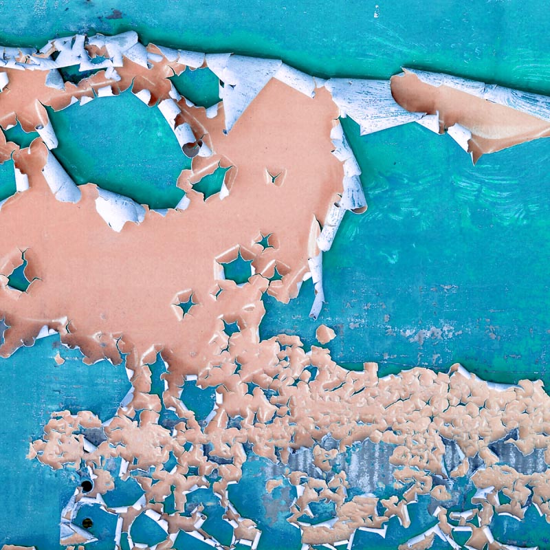 Peeling pastel paint revealing rustic texture