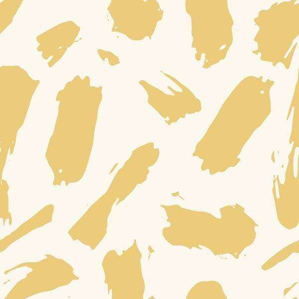Abstract pattern with gold paint smears on a cream background
