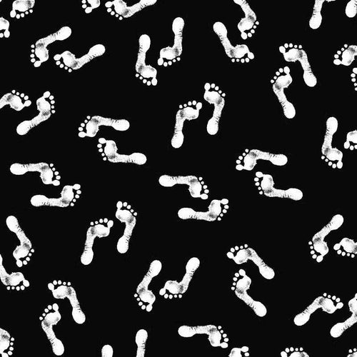 Scattered white footprints on a black background