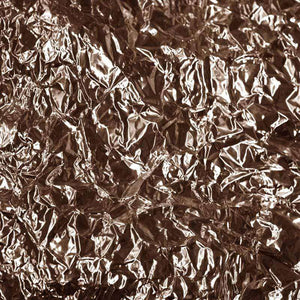 Crumpled metallic texture in copper tones