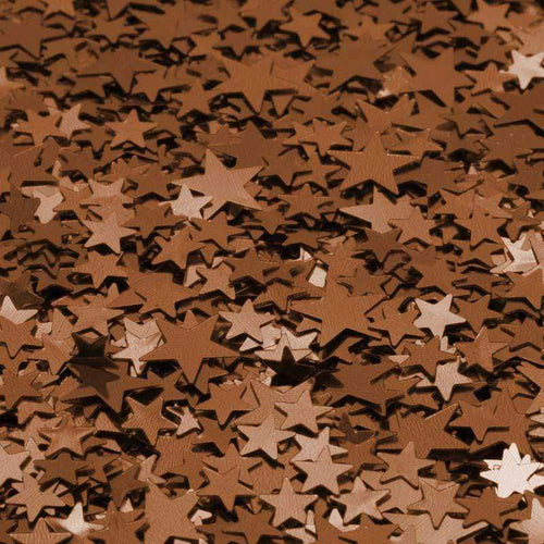 Scattered copper star confetti on a surface