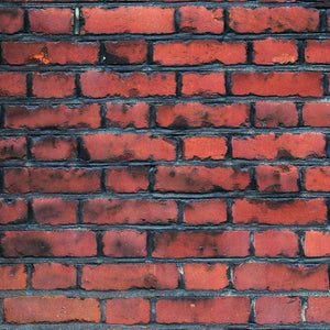Close-up of a red brick wall with visible texture
