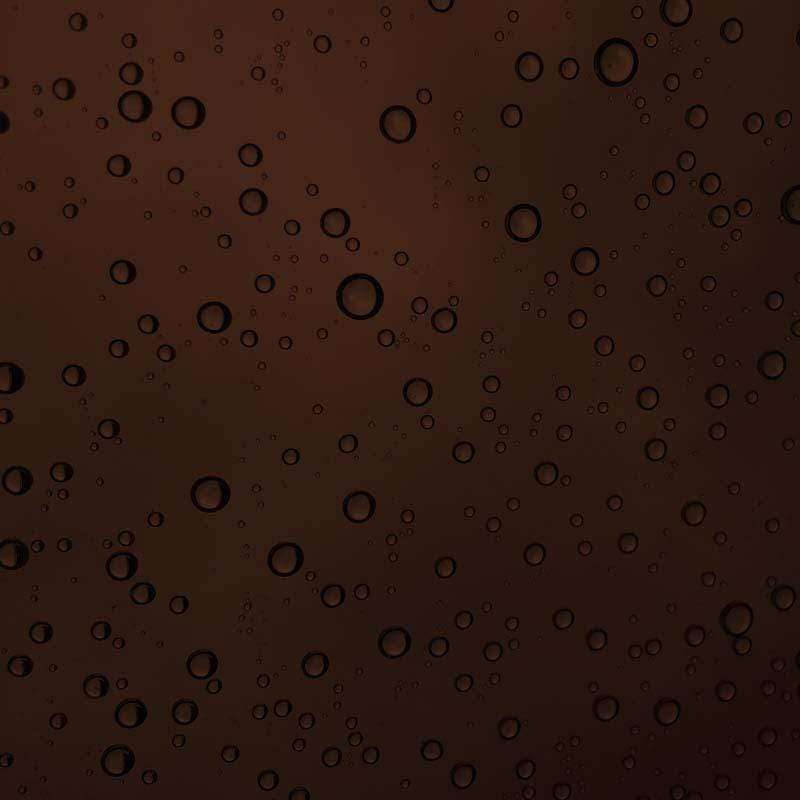 Water droplets pattern on a dark brown background