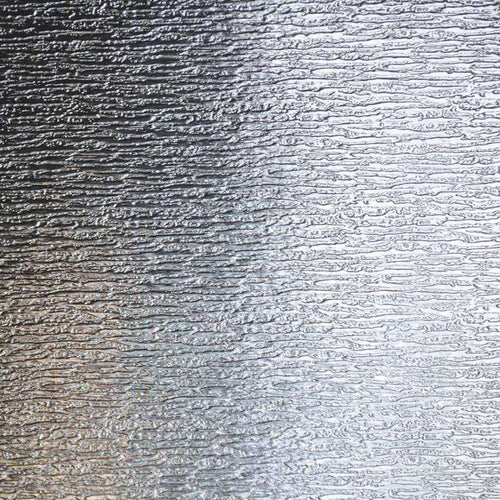 Textured silver metallic surface with ripple pattern