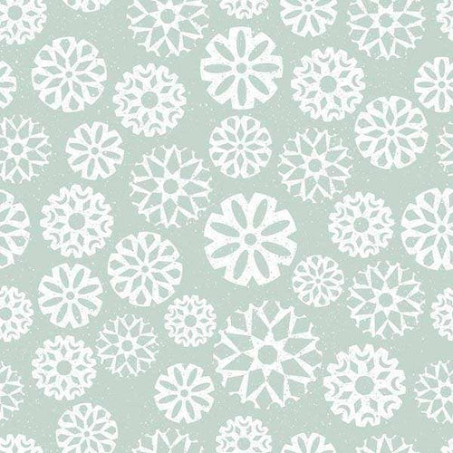 Assortment of white snowflakes on a pale green background