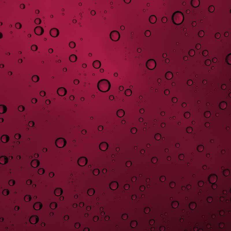 Water droplets pattern on a burgundy background