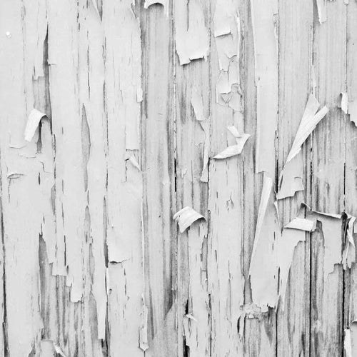 Black and white image of a weathered wooden surface with peeling paint