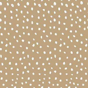 Abstract pattern of white irregular dots on a tan background