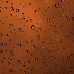 Water droplets on a warm amber background