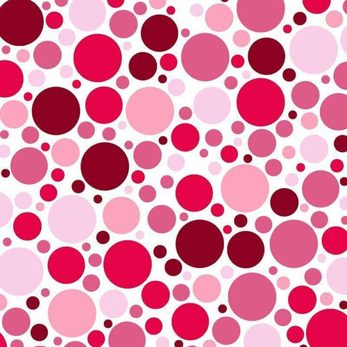 Vibrant assortment of pink and red polka dots on a white background