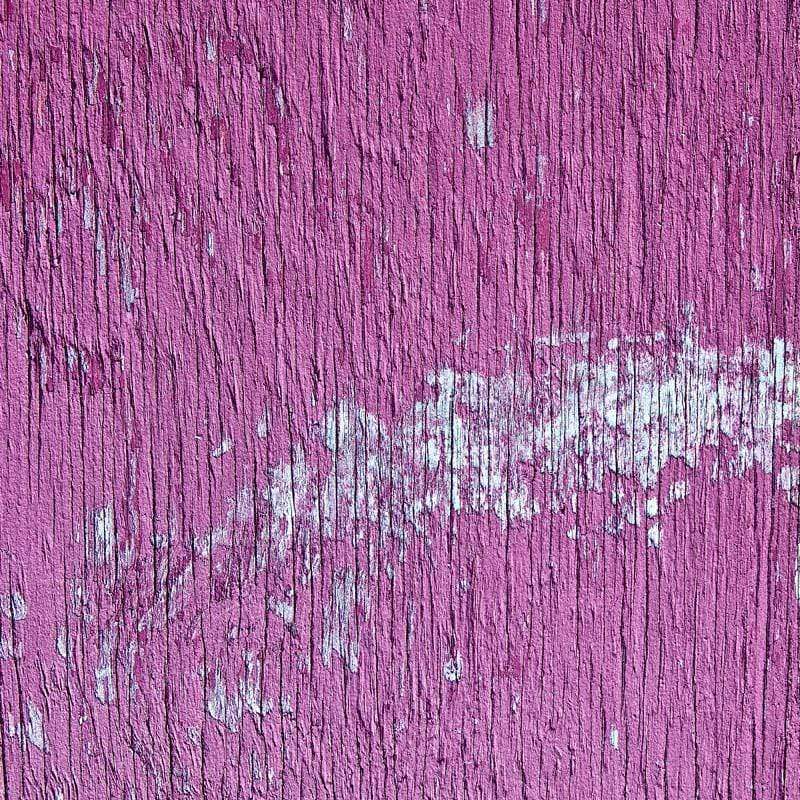 Textured magenta painted wood with peeling paint