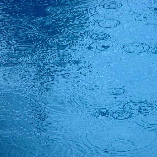 Raindrop patterns on tranquil blue water