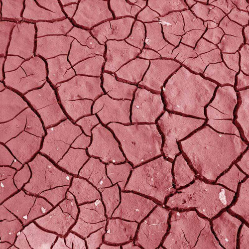 A textured pattern of cracked earth in shades of red