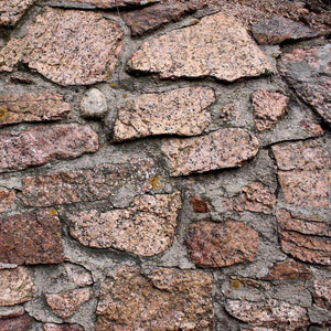 Textured stone wall with irregular granite blocks