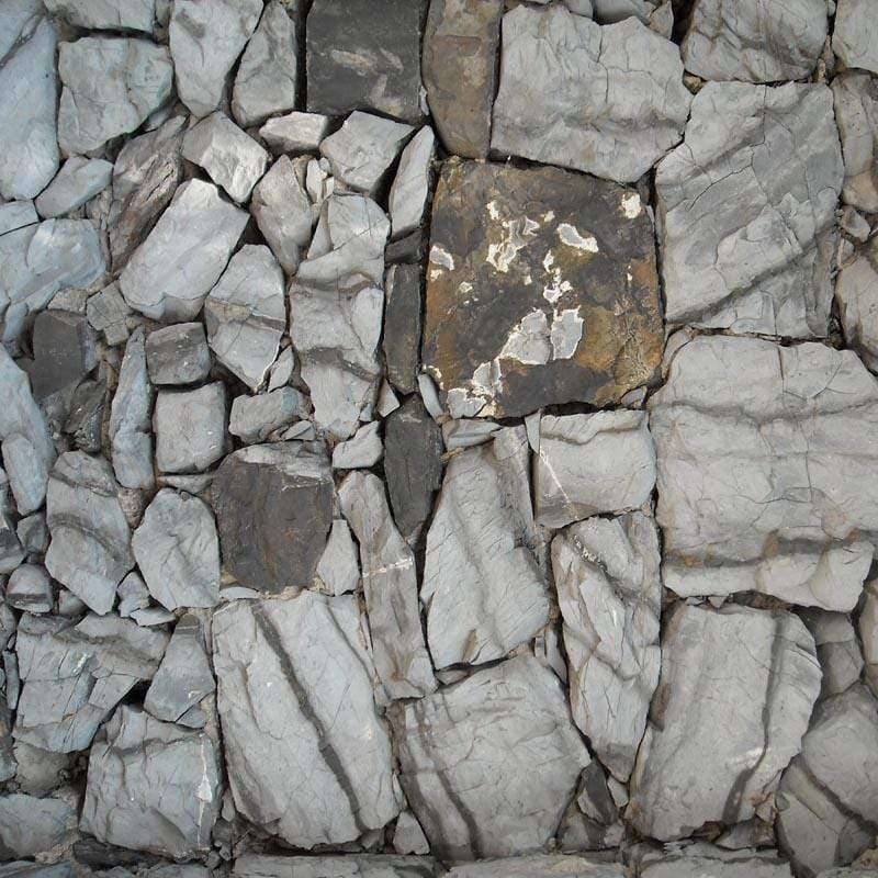 Textured stone wall pattern with various shades of gray