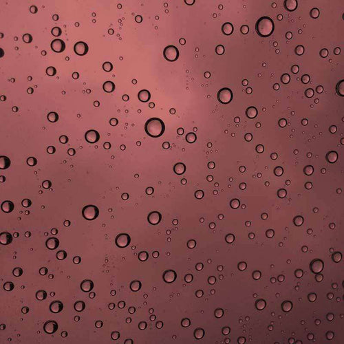 Water droplets on a rose-tinted surface