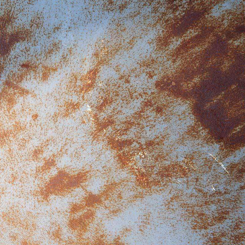 Rustic brown rust pattern on a pale blue background