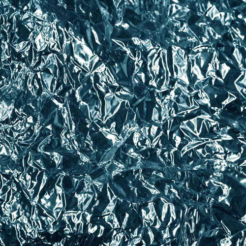 Close-up of crinkled foil texture with reflective surface