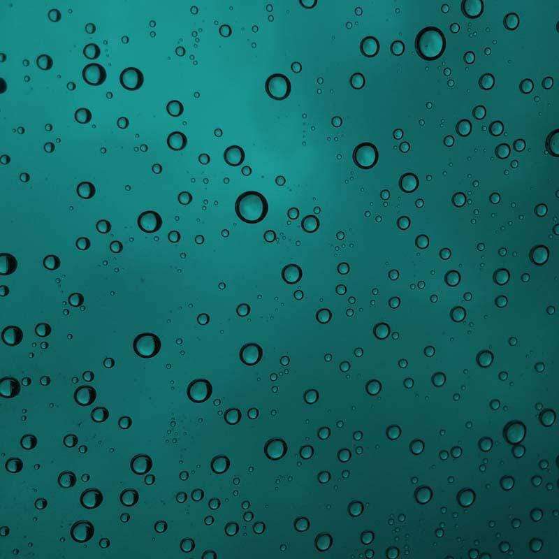 Water droplets on a teal surface