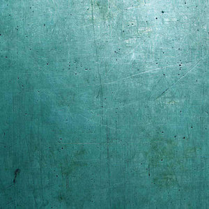 Textured emerald green surface with scratches and marks