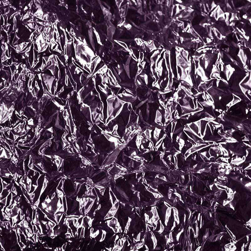 A crumpled foil texture in shades of purple