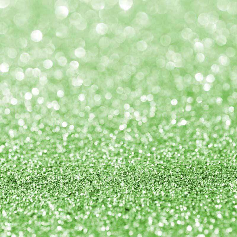 Glittering green texture with light bokeh